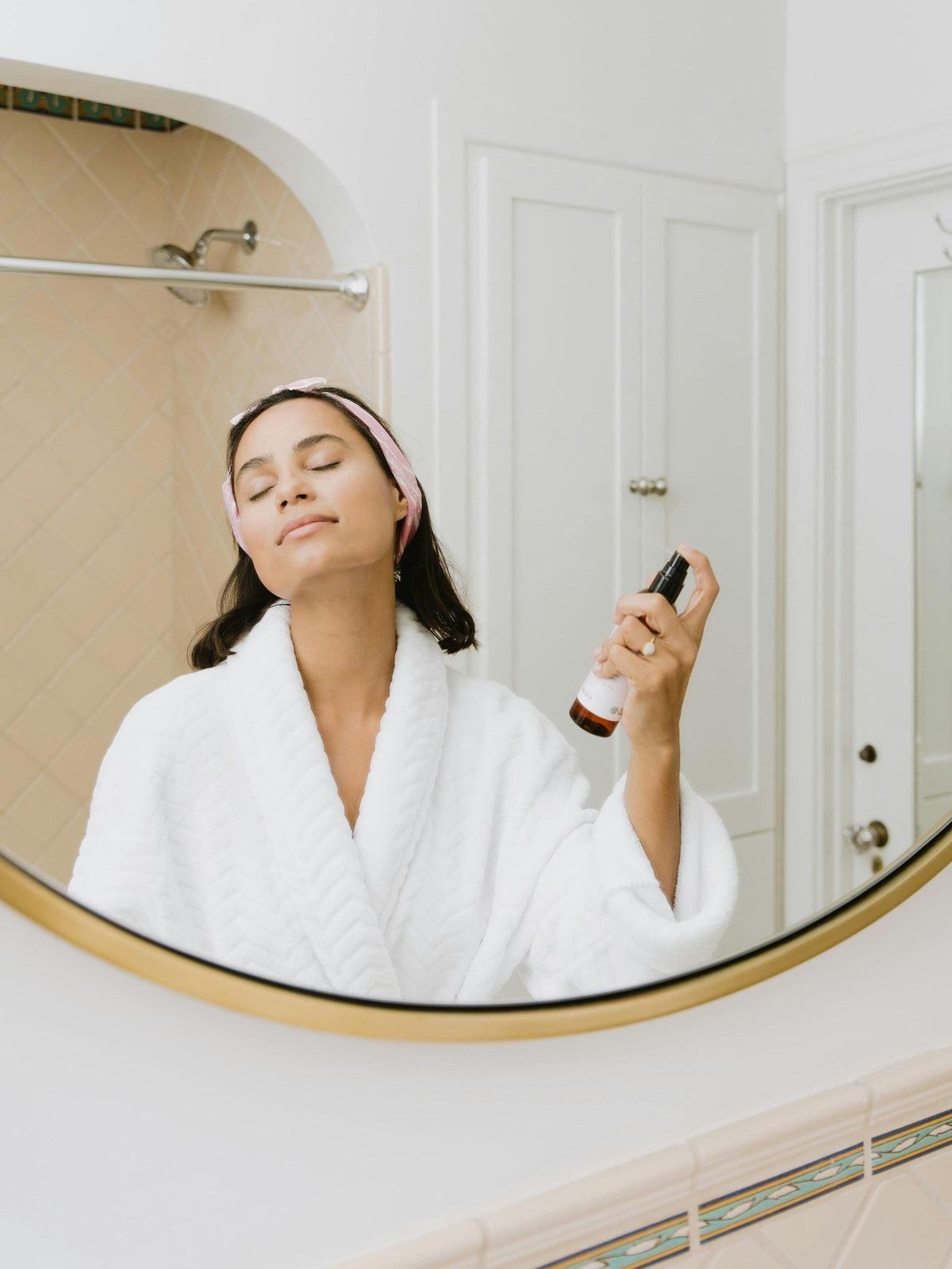 Femme prenant soin de sa peau dans une salle de bain lumineuse